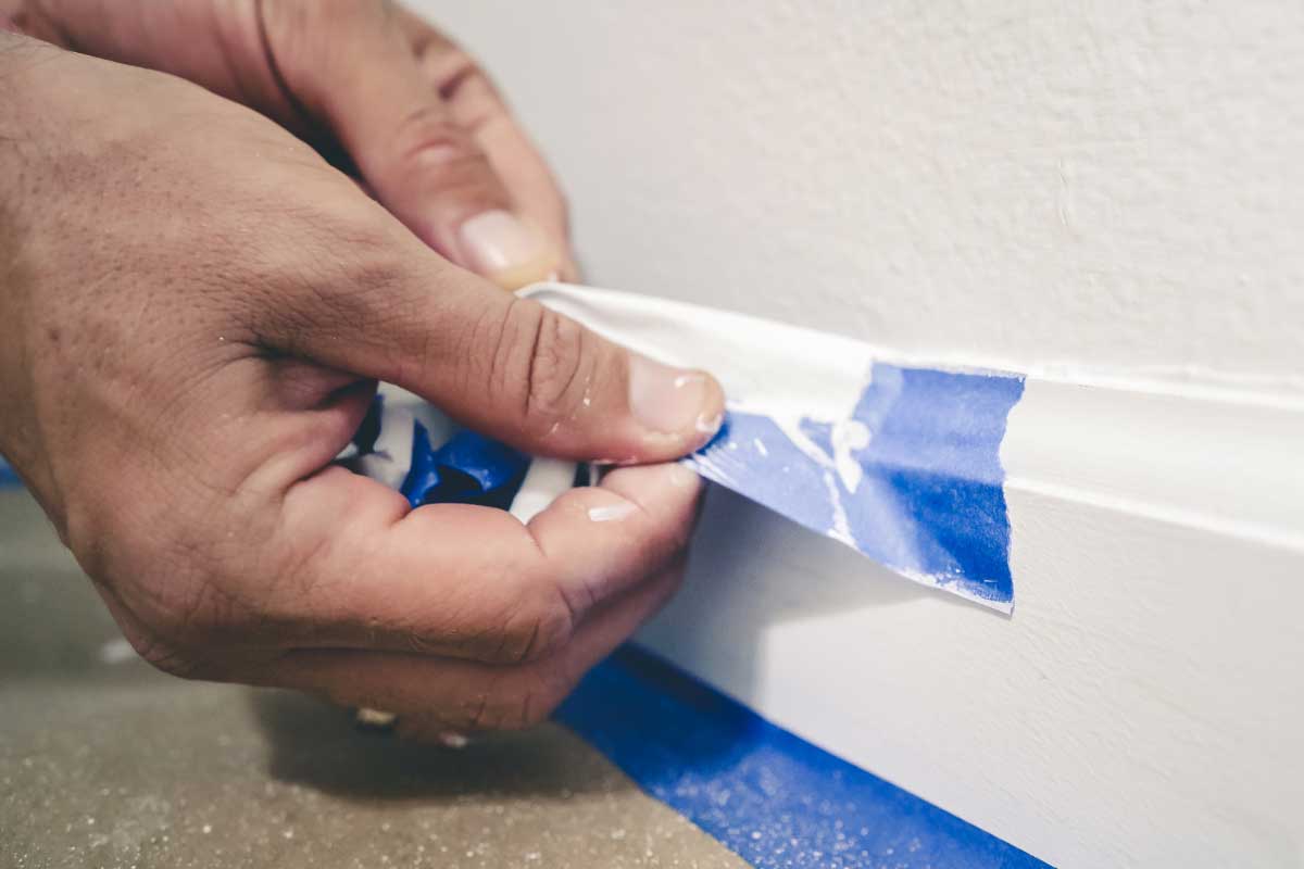 A decorator applying decorating tape